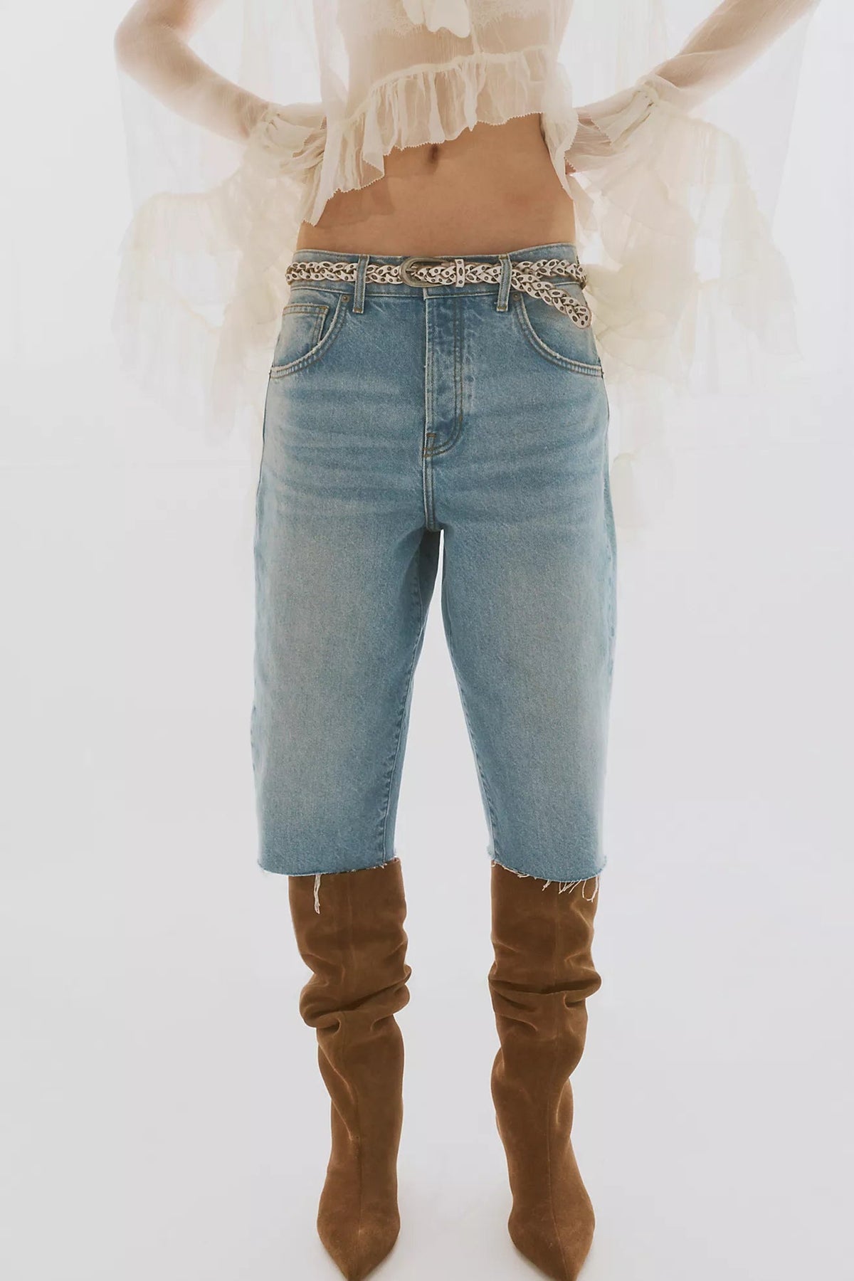 Trestles Clothing Company Sol Stud Belt featuring braided leather and metal studs worn with denim shorts and boots