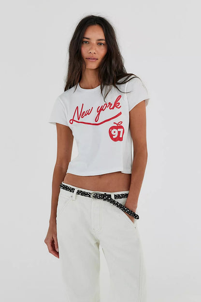 Trestles Clothing Company Sol Stud Belt in black leather with metal studs worn with a white New York graphic crop top