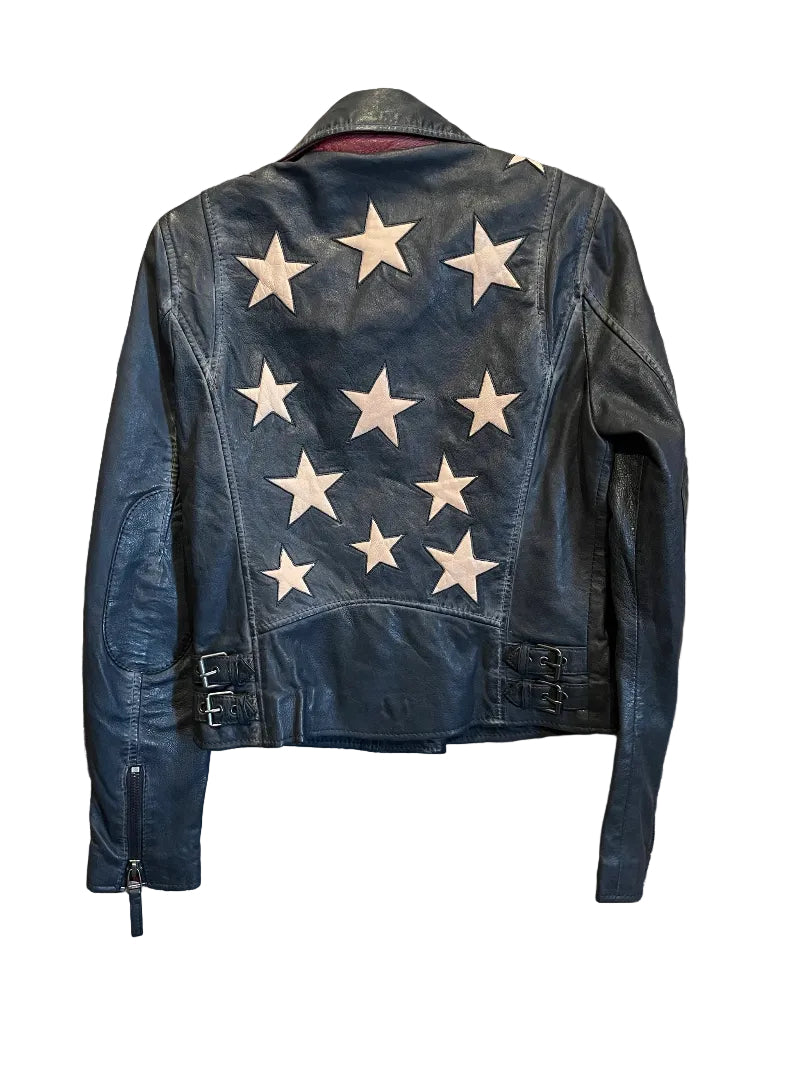 Trestles Clothing Company black lamb leather jacket with cream star patches on the back and side buckle details.