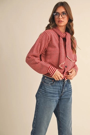Trestles Clothing Company red and white striped button-up sweater with an attached scarf worn by a woman in jeans.