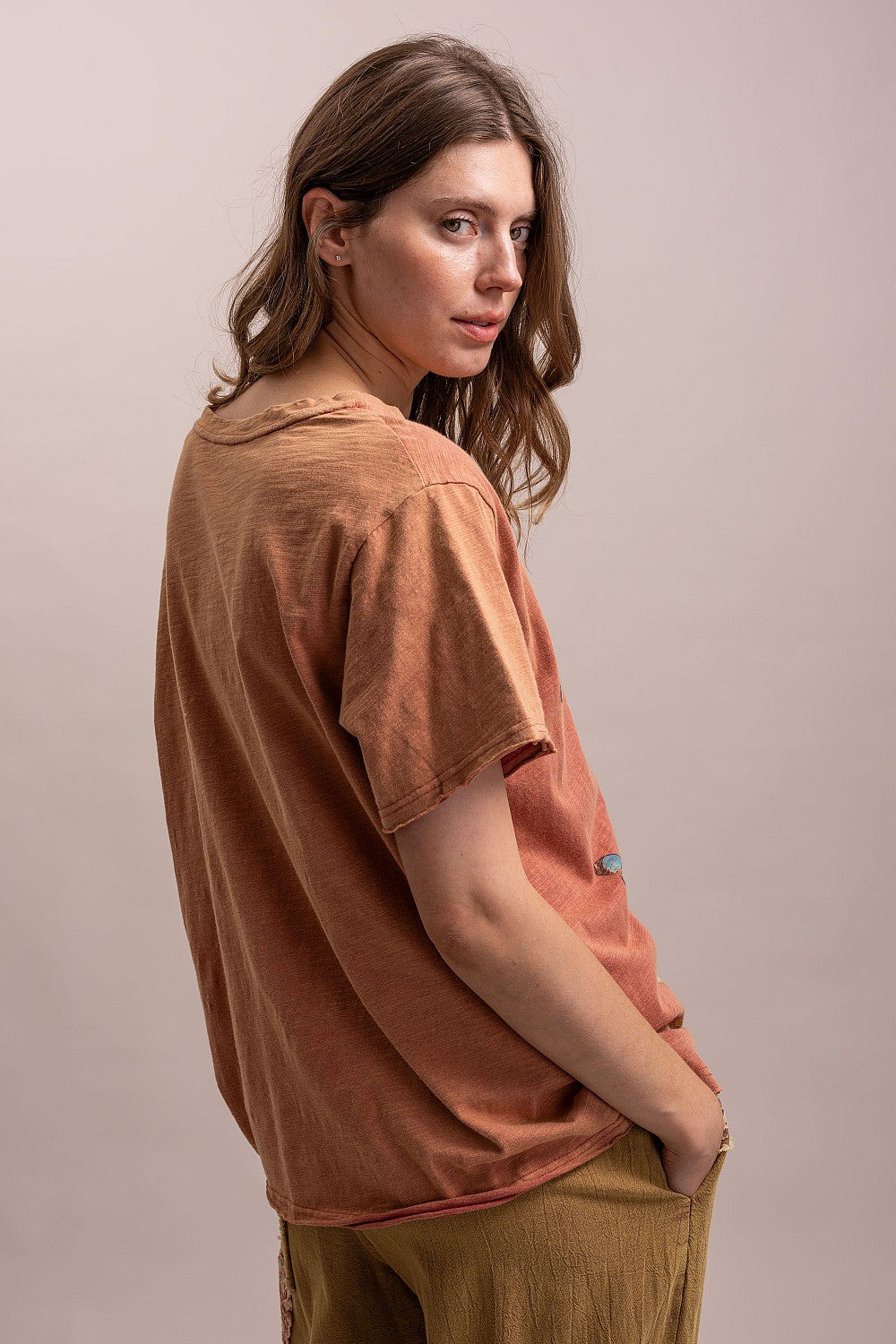 Trestles Clothing Company vintage washed terracotta cotton graphic tee with a relaxed fit worn by a woman