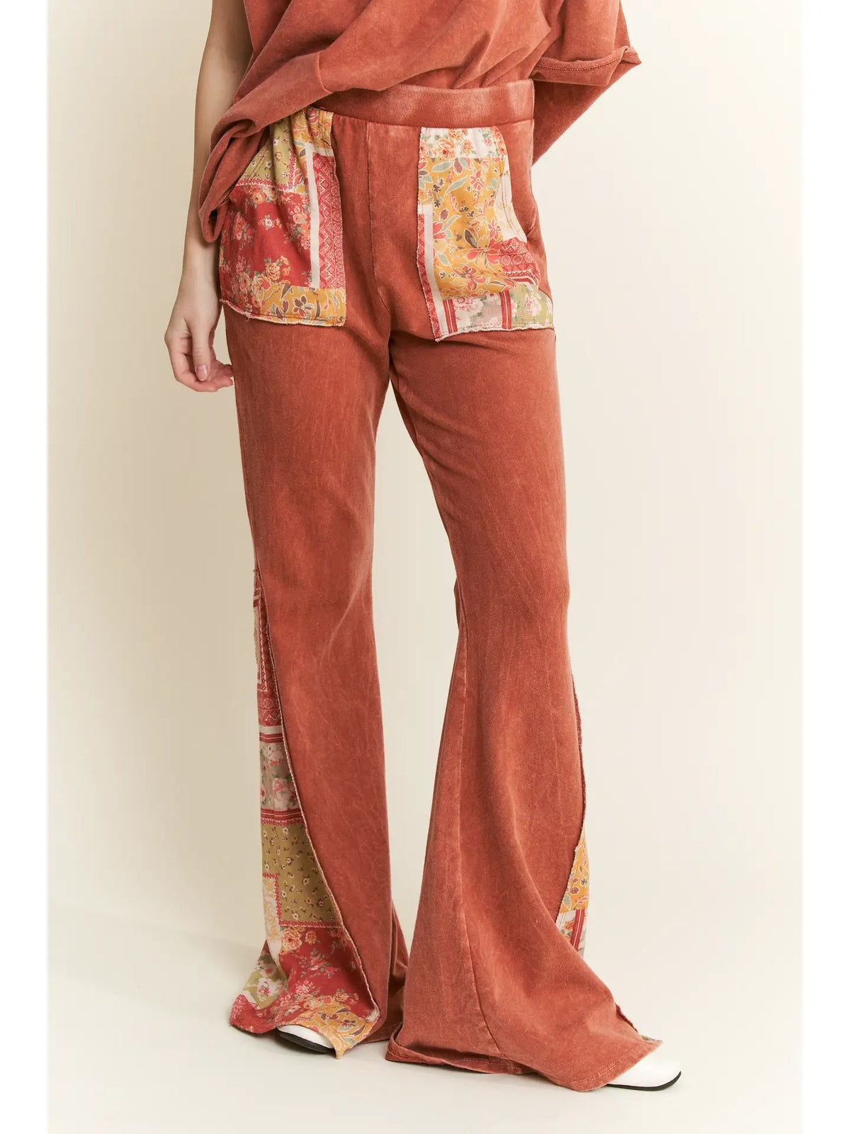 Trestles Clothing Company mineral washed bell bottom pants in rust with boho floral patch pockets and side panels
