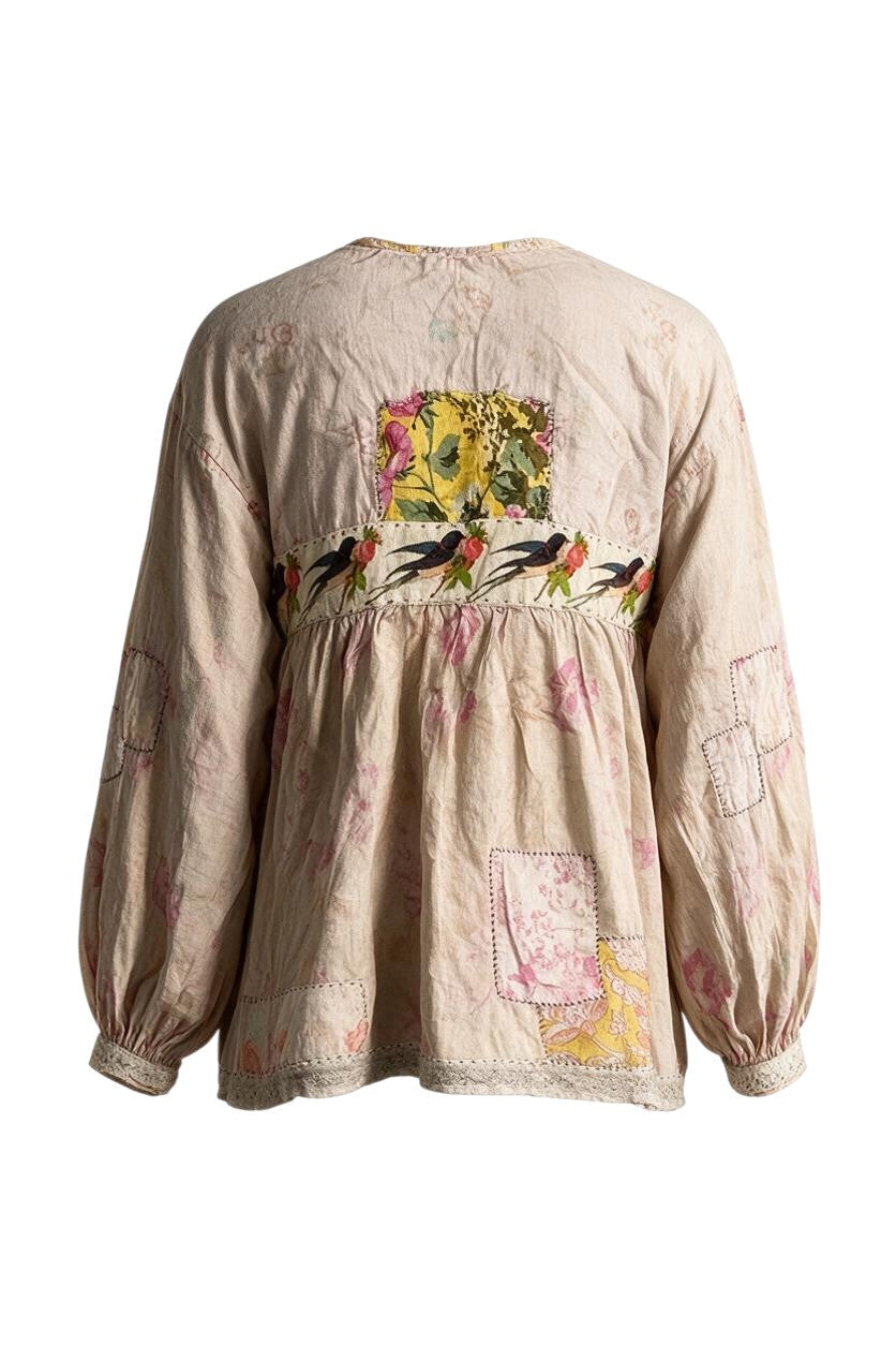 Back view of Trestles Clothing Company Weathered Wildflower Top featuring faded roses, floral appliqués, and patches.