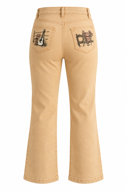 Trestles Clothing Company high-rise wide leg jeans in sand wash denim with vintage Western back pocket graphics.