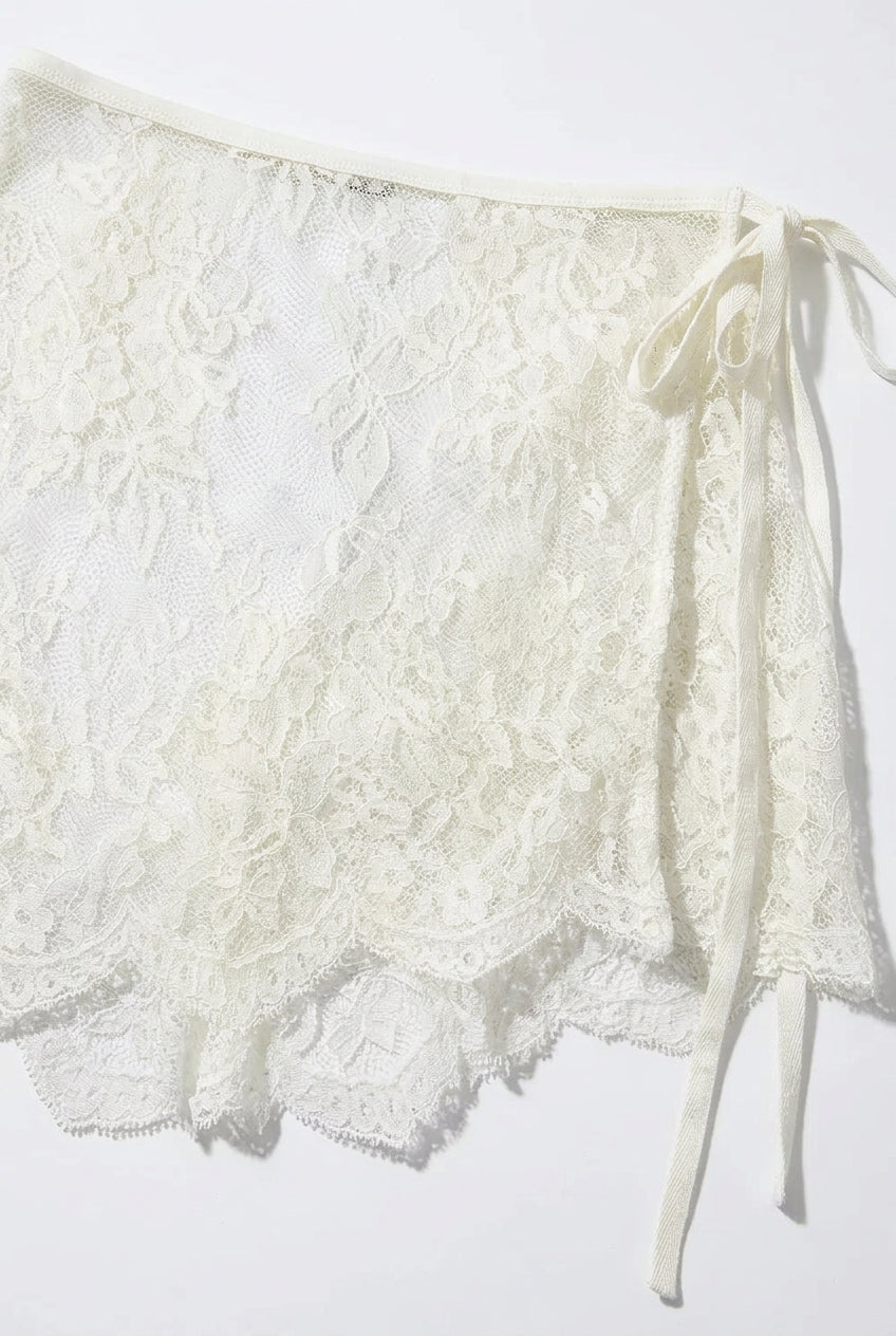 Trestles Clothing Company white asymmetrical lace skirt overlay with a tie-side closure and scalloped hem.