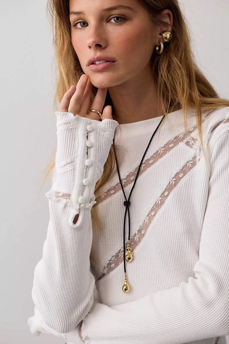 Trestles Clothing Company white waffle knit long sleeve top with lace panels, button cuffs, and lettuce edge trim