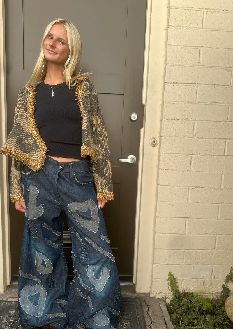 Trestles Clothing Company wide leg dark denim jeans with heart patches and distressing worn by a blonde model