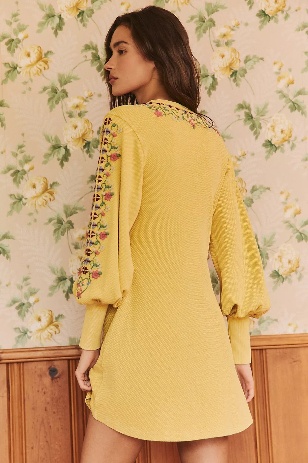 Trestles Clothing Company yellow boho knit mini dress with floral embroidery and balloon sleeves, back view.