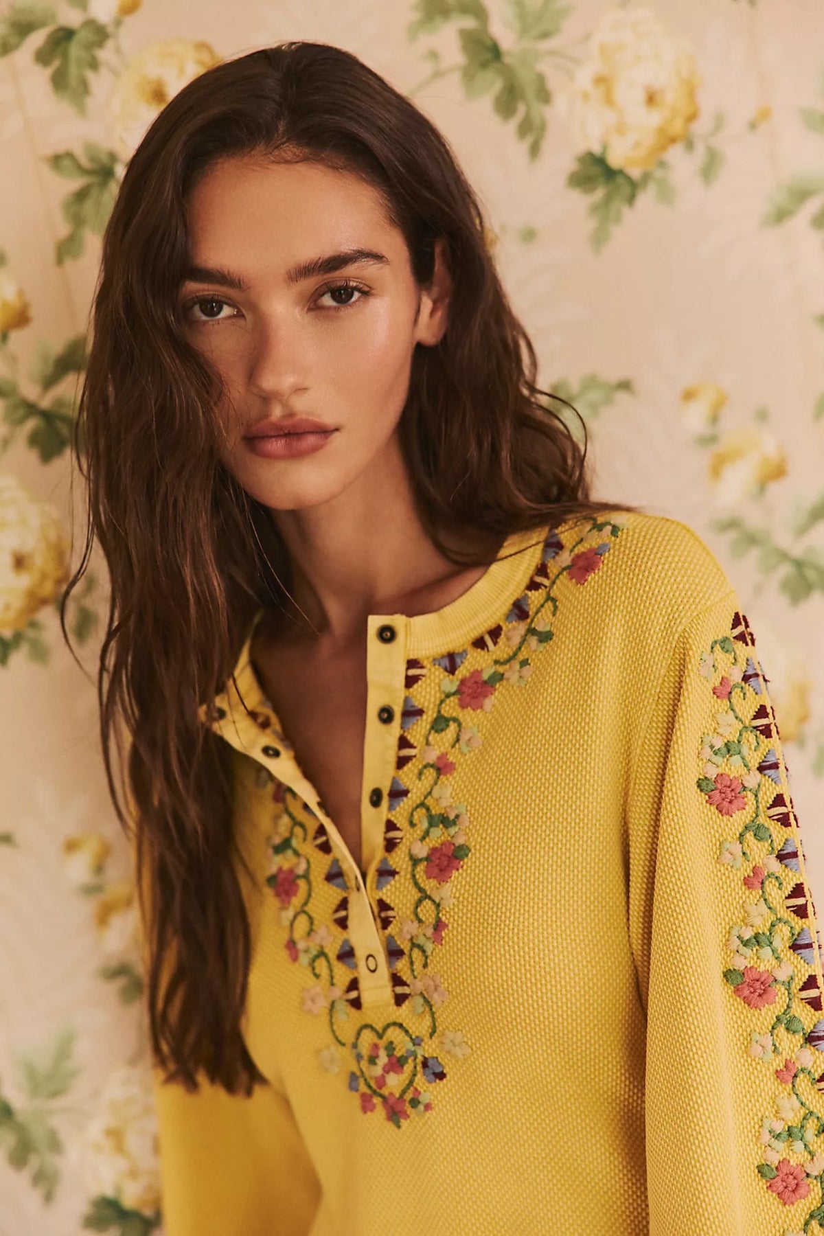 Trestles Clothing Company yellow ribbed knit mini dress with floral embroidery, henley neckline, and balloon sleeves.