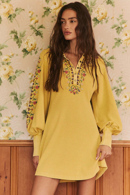 Trestles Clothing Company yellow ribbed knit mini dress with balloon sleeves, floral embroidery, and henley neckline.