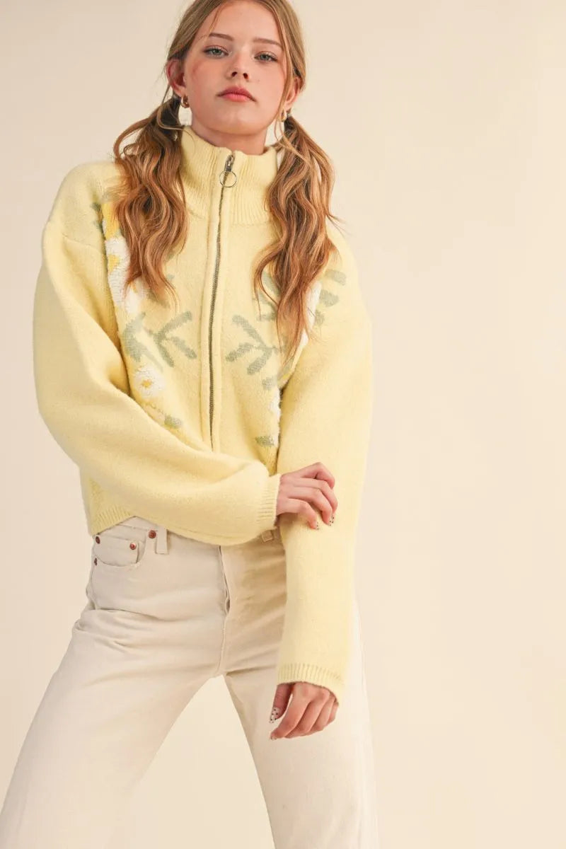 Trestles Clothing Company yellow floral zip-up knit sweater with puff sleeves and stand collar on a model