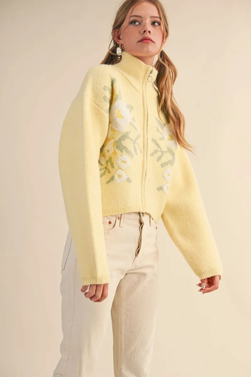 Trestles Clothing Company pale yellow floral knit zip-up sweater with puff sleeves and stand collar on a model