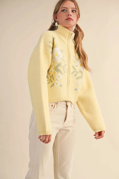 Trestles Clothing Company pale yellow floral knit zip-up sweater with puff sleeves and stand collar on a model